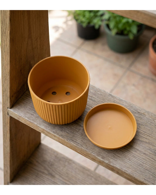 Fndzk Archrib Plastic Planter 9 in Ochre with Saucer - Lifestyle view